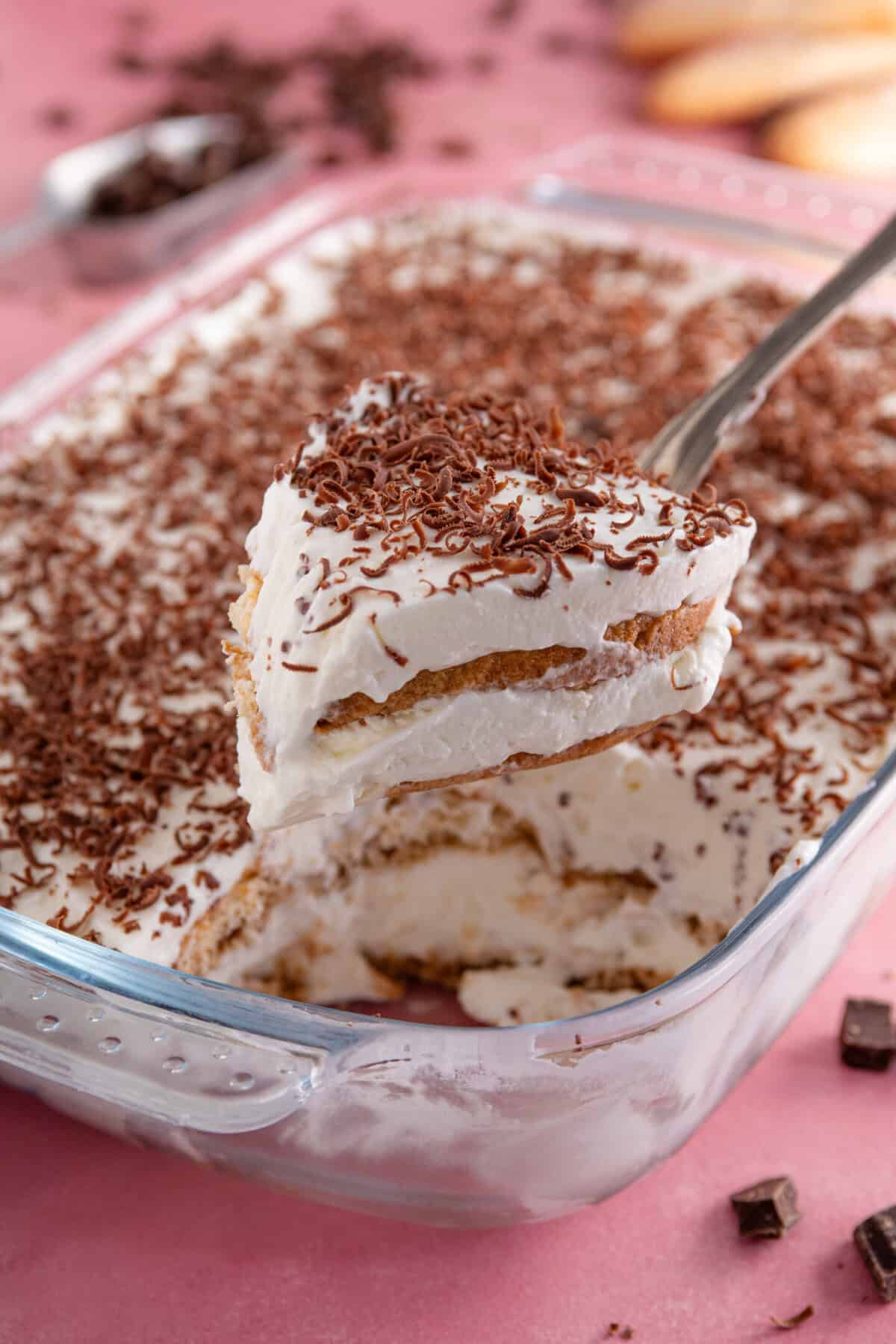 A spoon holding up a portion of gluten free tiramisu.