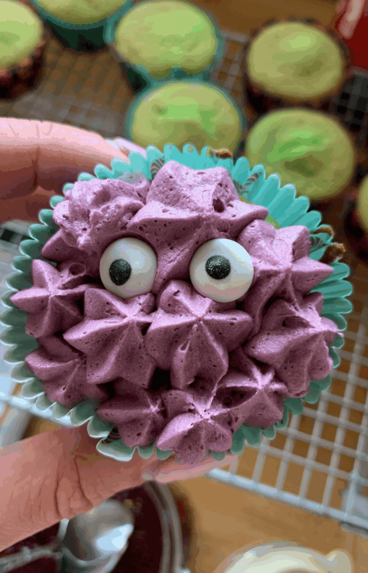 Pipe on the buttercream frosting and add edible eyes to finish.