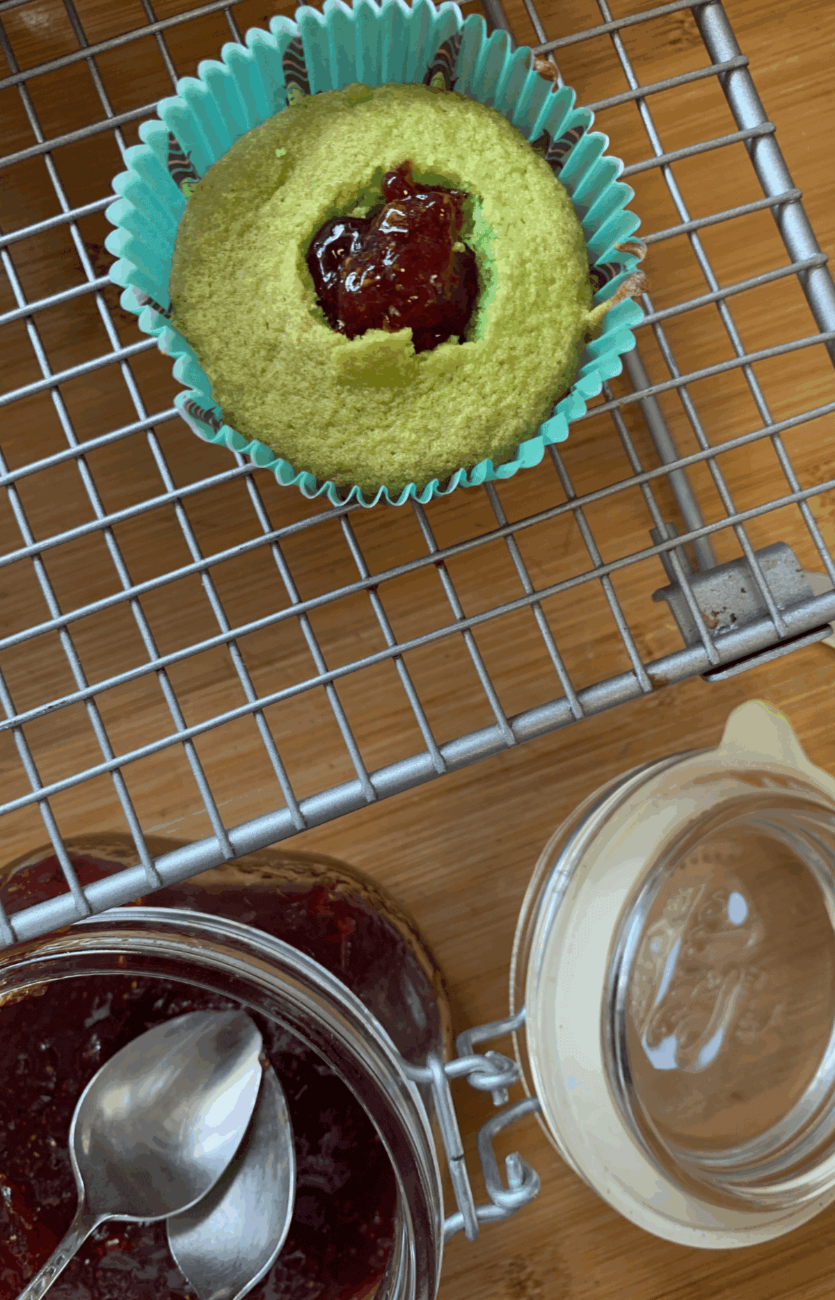 Cut a well in the centre of each cupcake and fill it with jam.