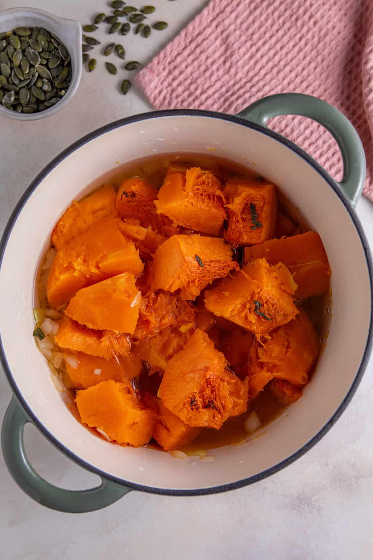 Remove the pumpkin flesh from the skin and add to the pan with the onions.