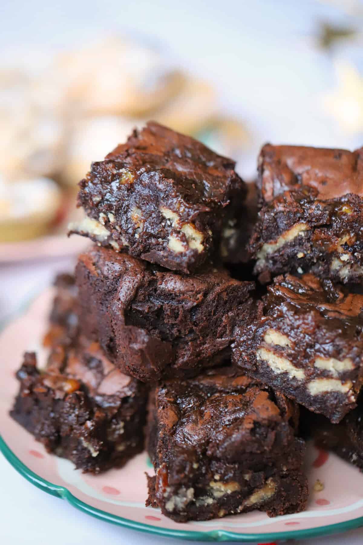 A stack of fudgy gluten free brownies with chunks of mince pies inside.