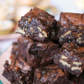 A stack of fudgy gluten free brownies with chunks of mince pies inside.