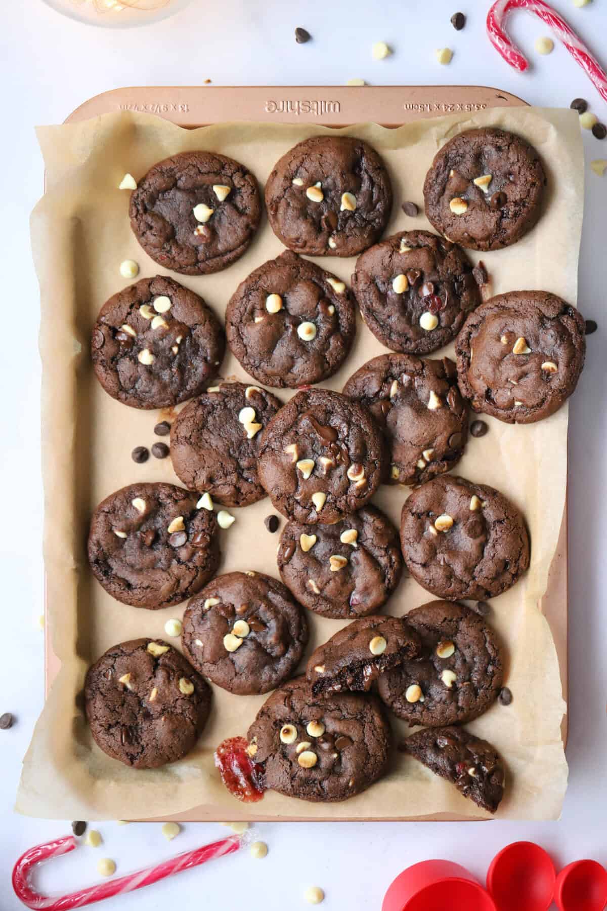 A tray of gluten free peppermint bark cookies with white chocolate chips and candy canes.