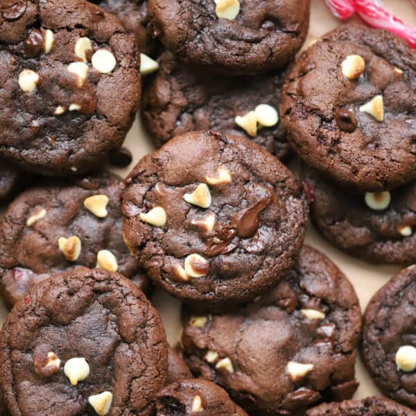 A pile of gluten free peppermint bark cookies - gooey chocolate mint cookies with chunks of white and dark chocolate.