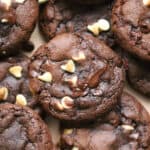 A pile of gluten free peppermint bark cookies - gooey chocolate mint cookies with chunks of white and dark chocolate.