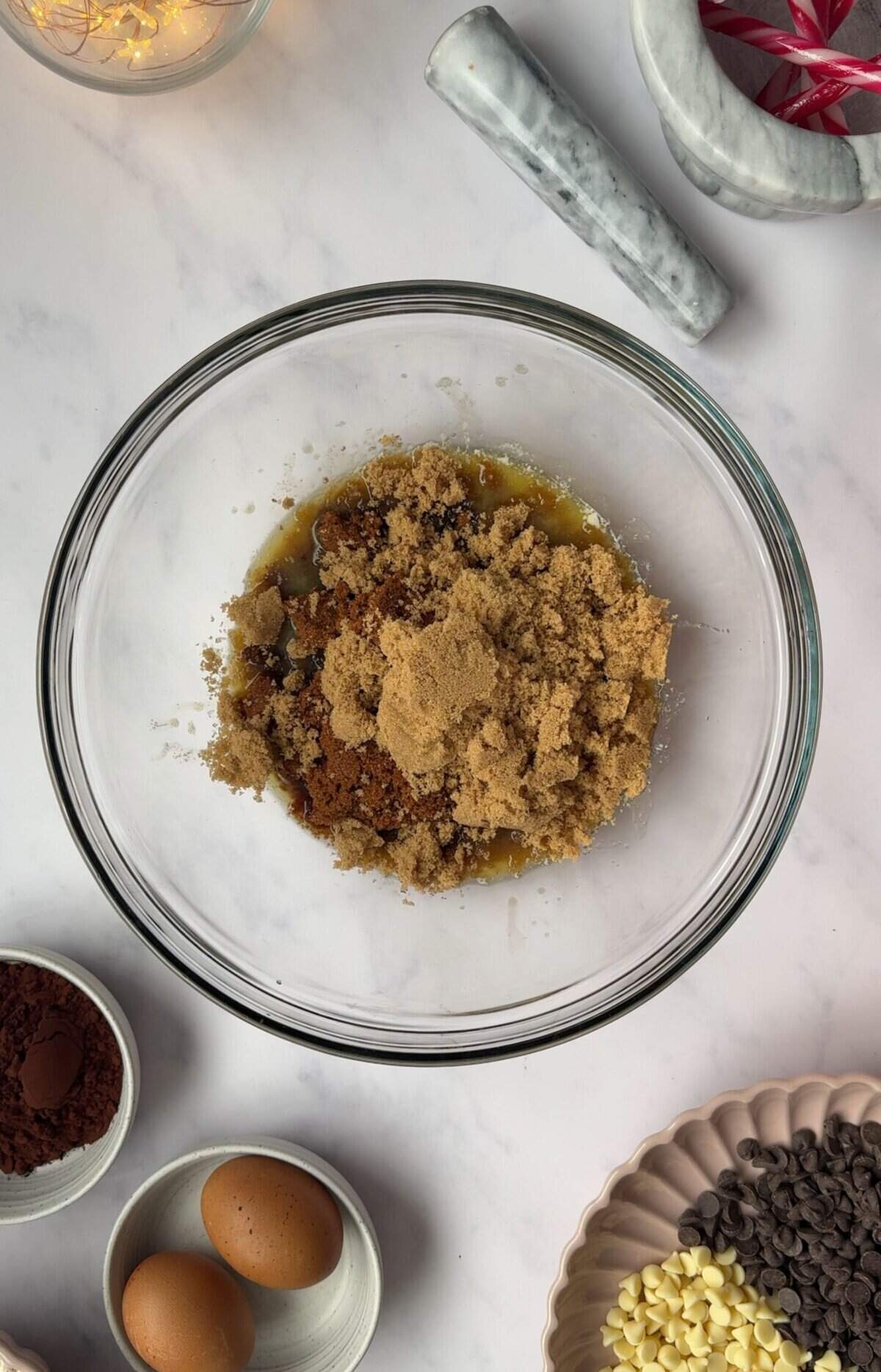 A process shot showing a bowl with sugars, mint extract and melted butter.