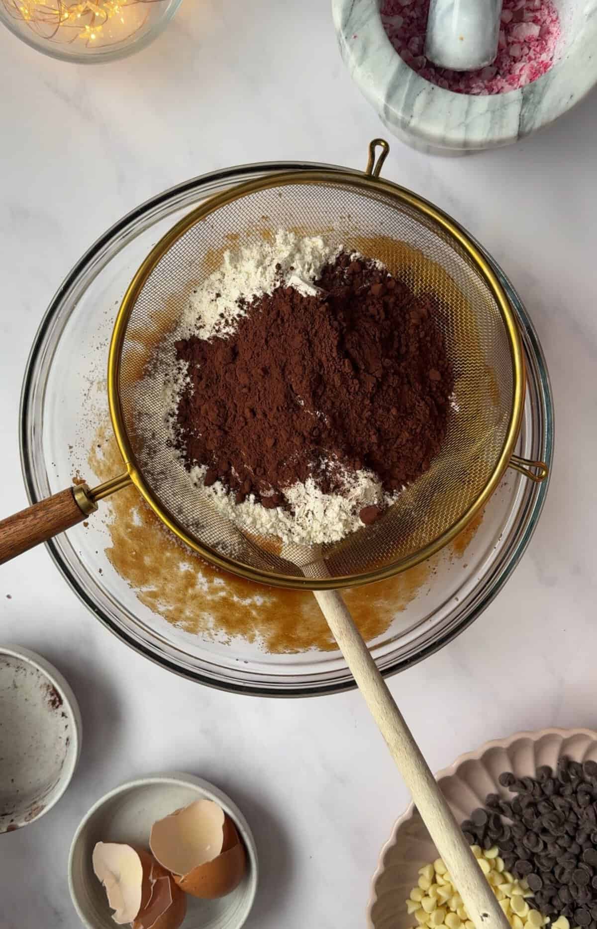 Sift in the gluten free flour, cocoa powder, xanthan gum, bicarb and baking powder.