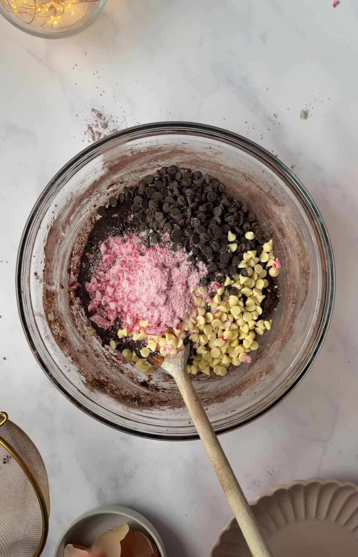 Add the chocolate chunks and crushed candy canes to the cookie dough.