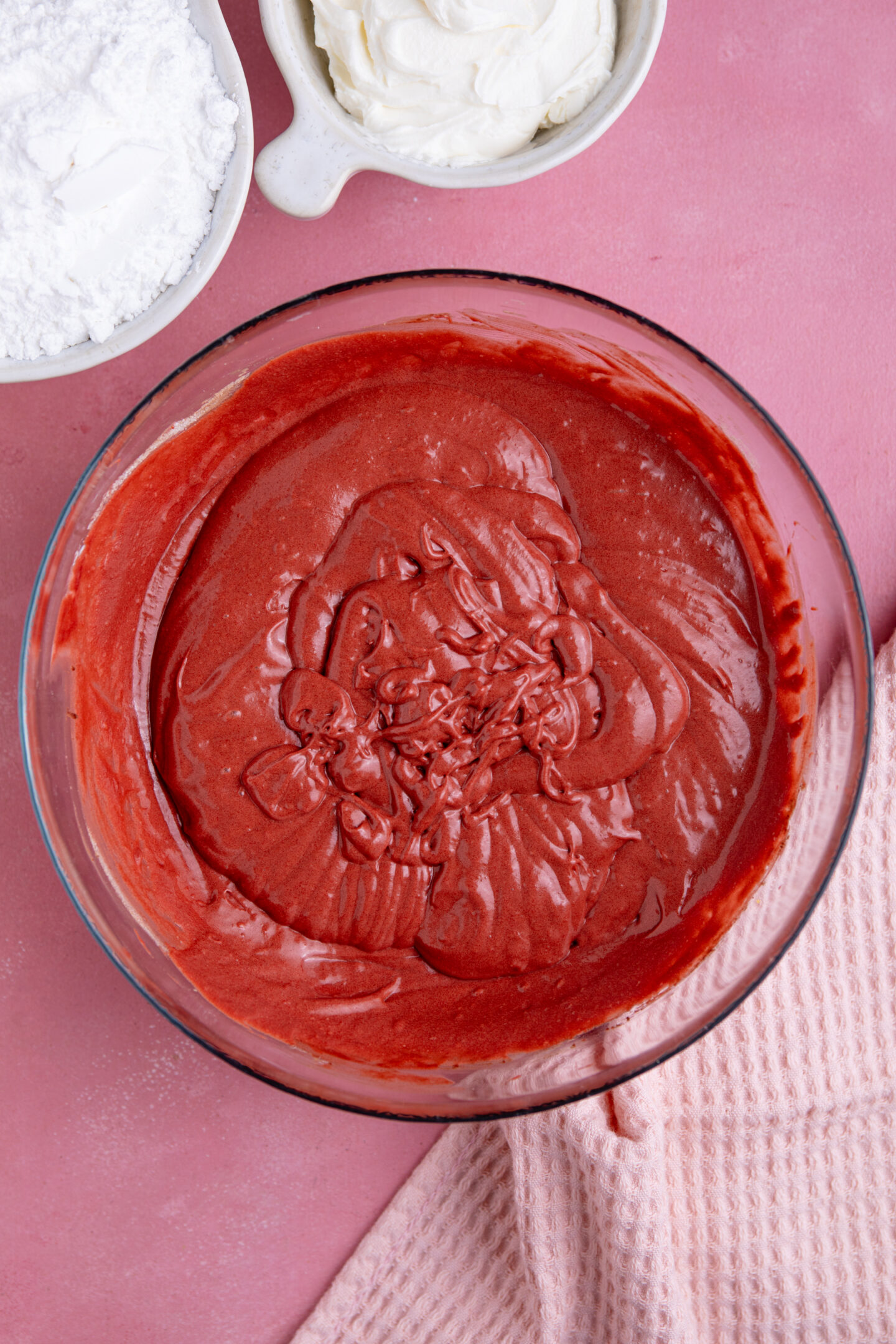 Process shot showing the red velvet cake batter in a mixing bowl.