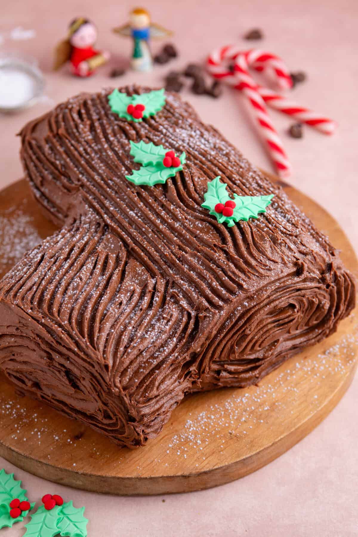 A gluten free chocolate yule log on a wooden board.