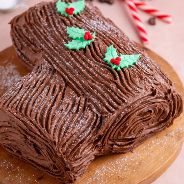 A gluten free chocolate yule log on a wooden board.