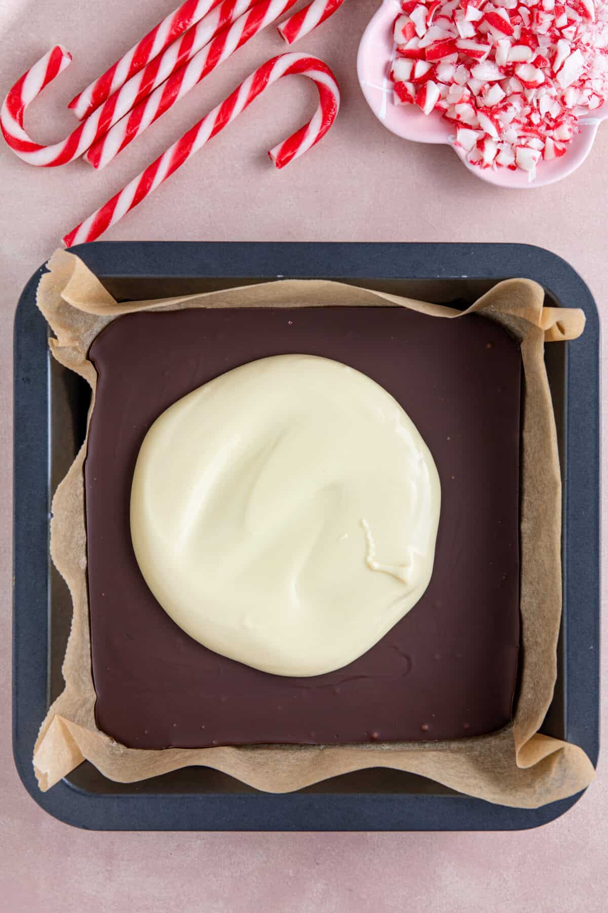 Pour the melted white chocolate on top of the dark chocolate.