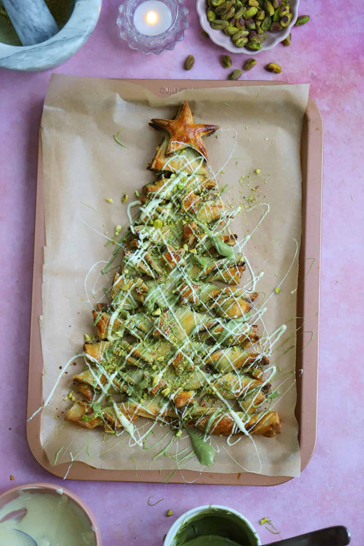 A gluten free puff pastry christmas tree with pistachio spread and white chocolate.