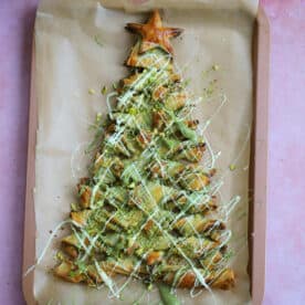 A gluten free puff pastry christmas tree with pistachio spread and white chocolate.