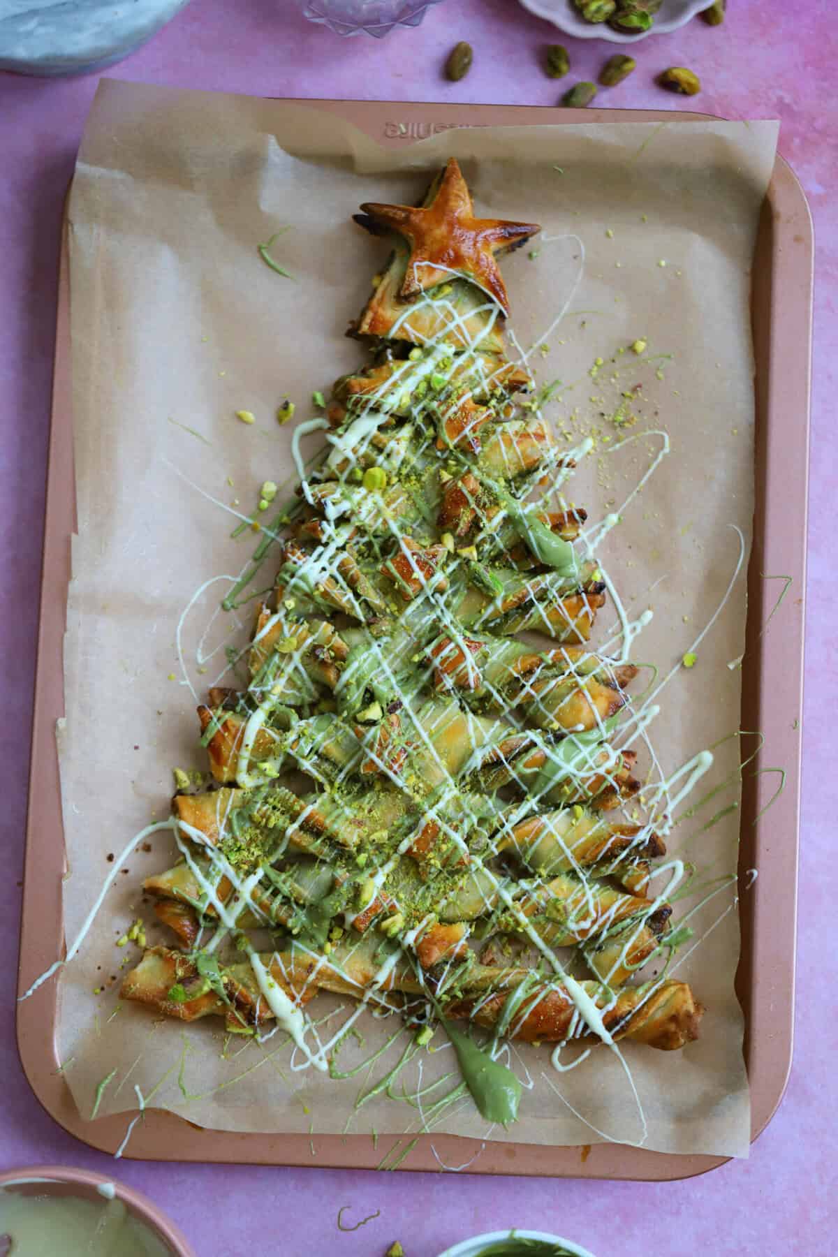 Decorate the baked tree with drizzles of melted white chocolate and pistachio spread.