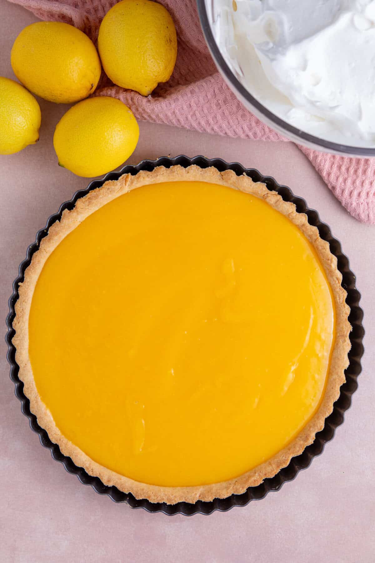 Process shot of a gluten free lemon meringue pie recipe showing the lemon curd in the pastry case.