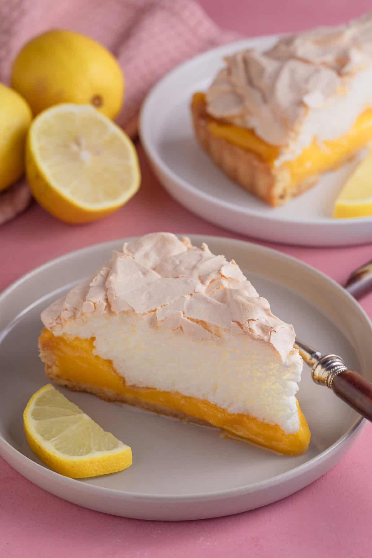 A slice of gluten free lemon meringue pie on a plate.