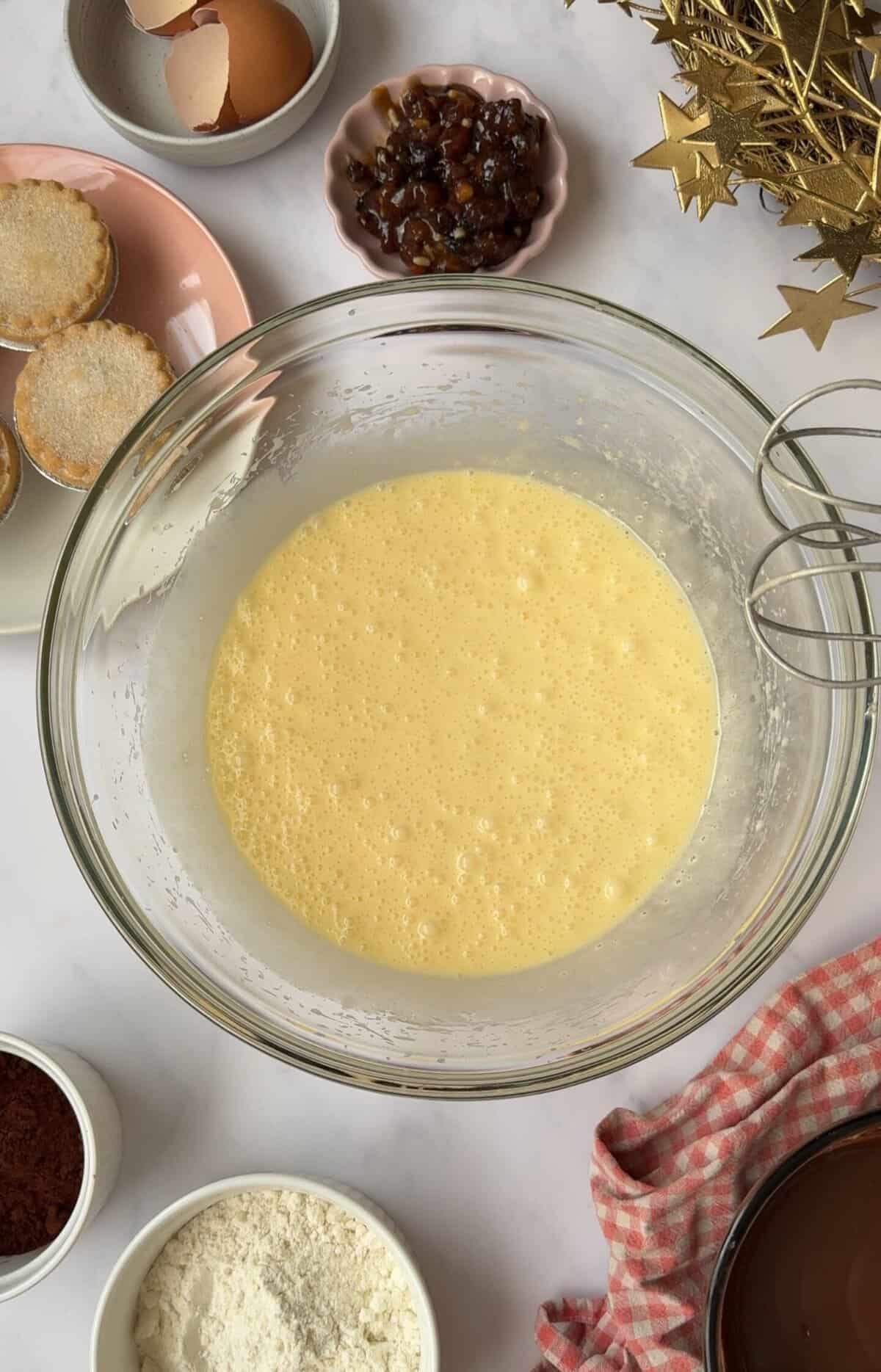 Process shot of mince pie brownies recipe showing how the mixture looks after whisking the eggs in.