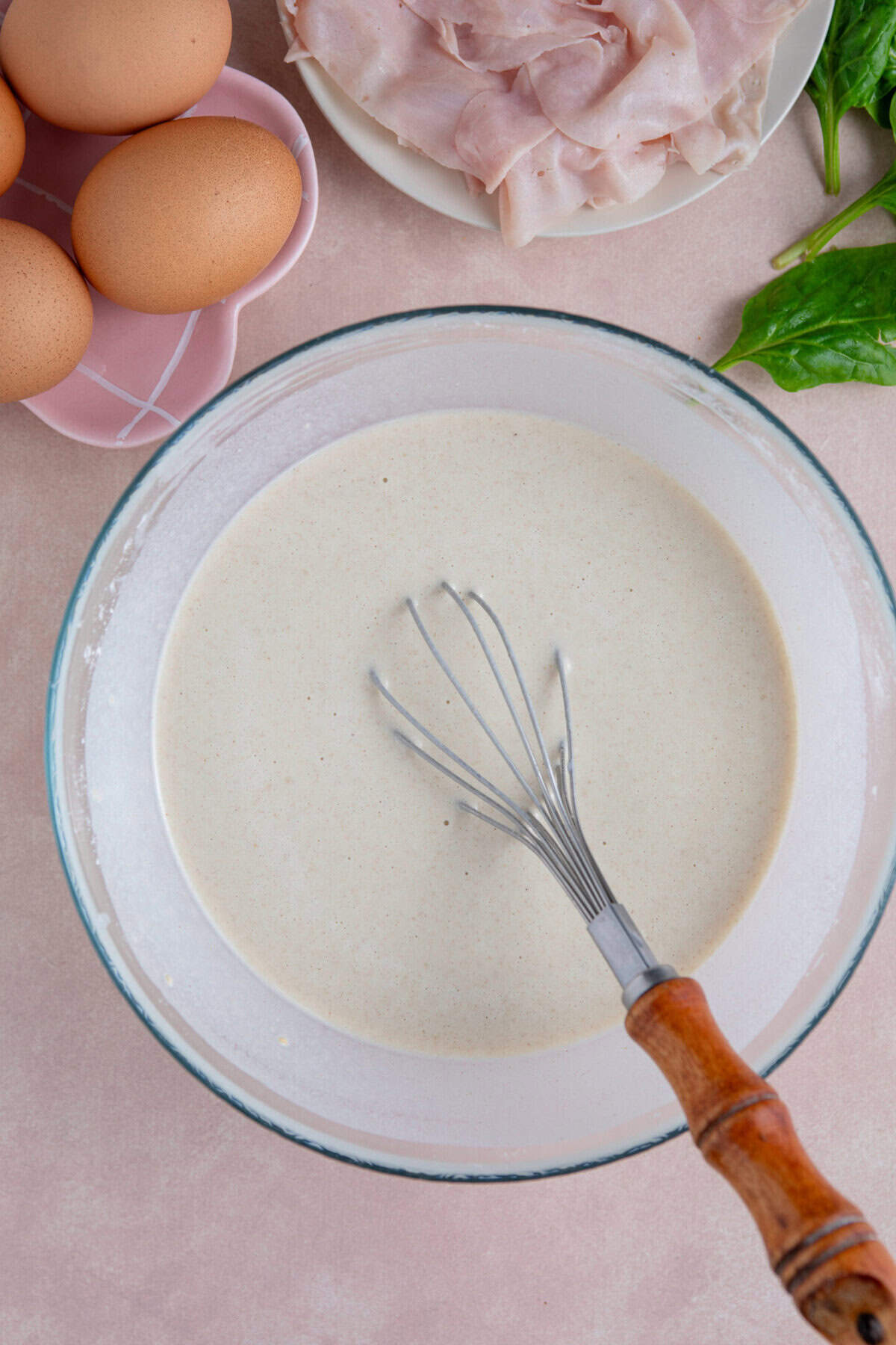 Process shot of buckwheat pancakes recipe showing the batter in a mixing bowl.