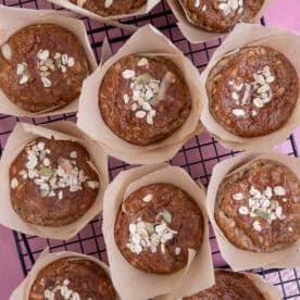 Overhead shot of gluten free breakfast muffins on a cooling rack sprinkled with oats.