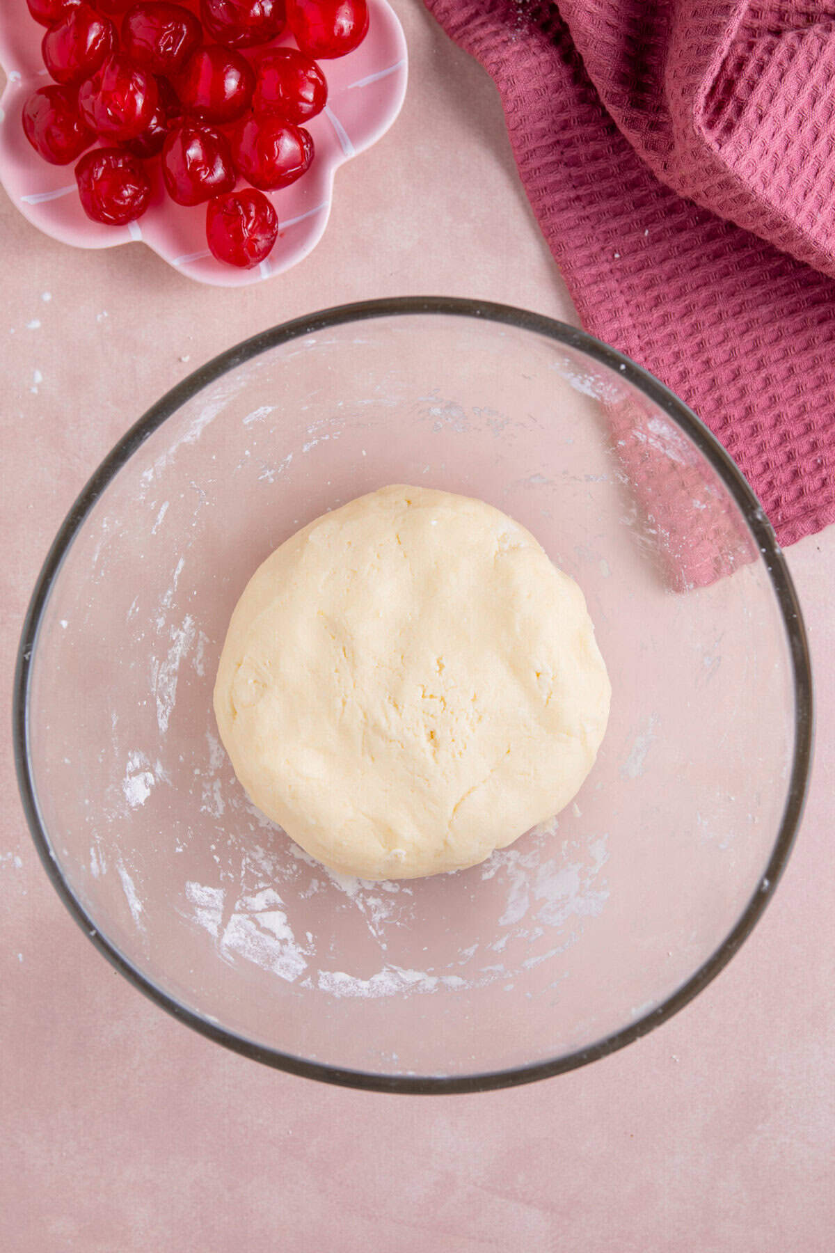 Process shot of gluten free cherry bakewells recipe showing the gluten free pastry dough in a bowl.
