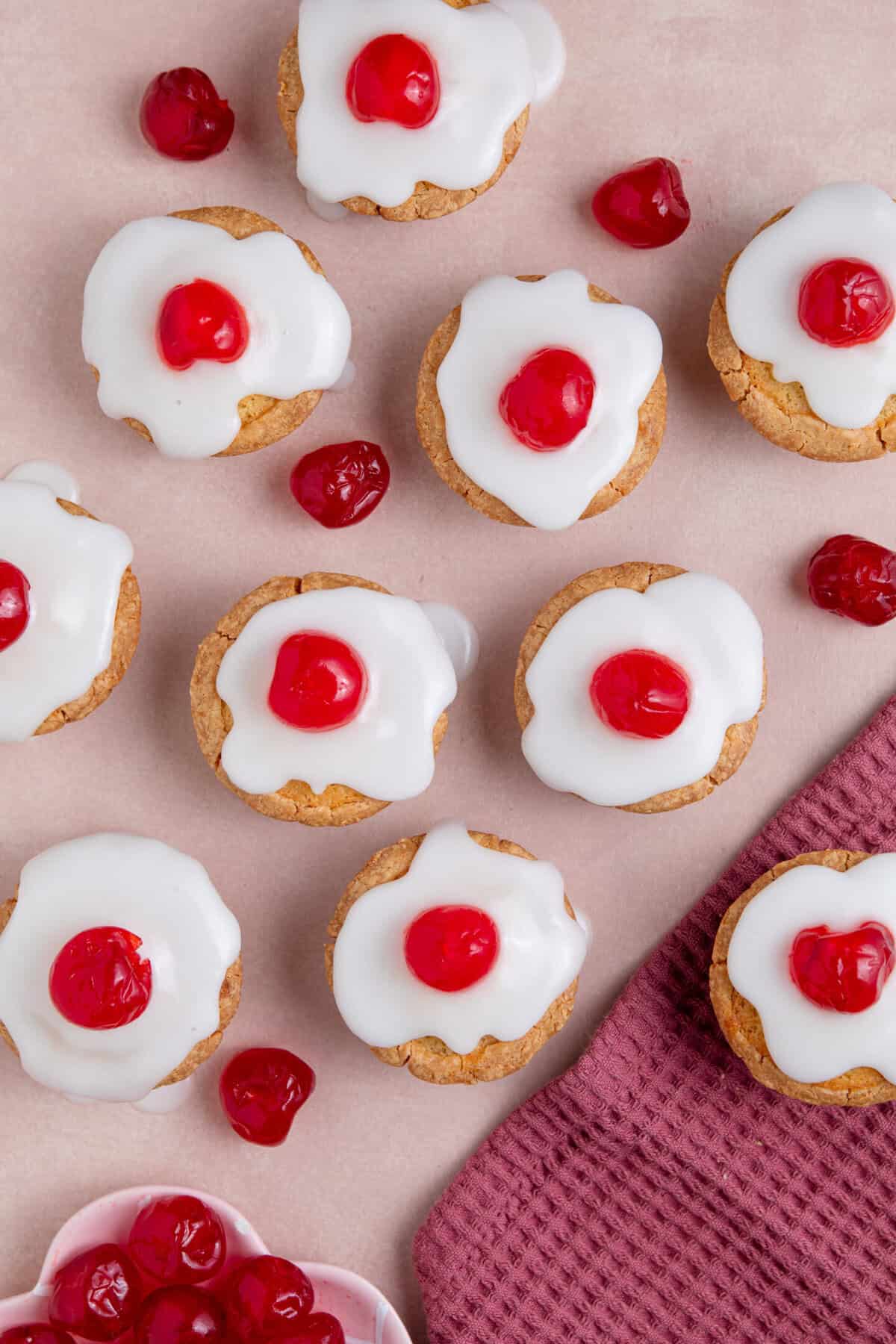 Process shot of gluten free cherry bakewells recipe showing the finished, iced bakewells.