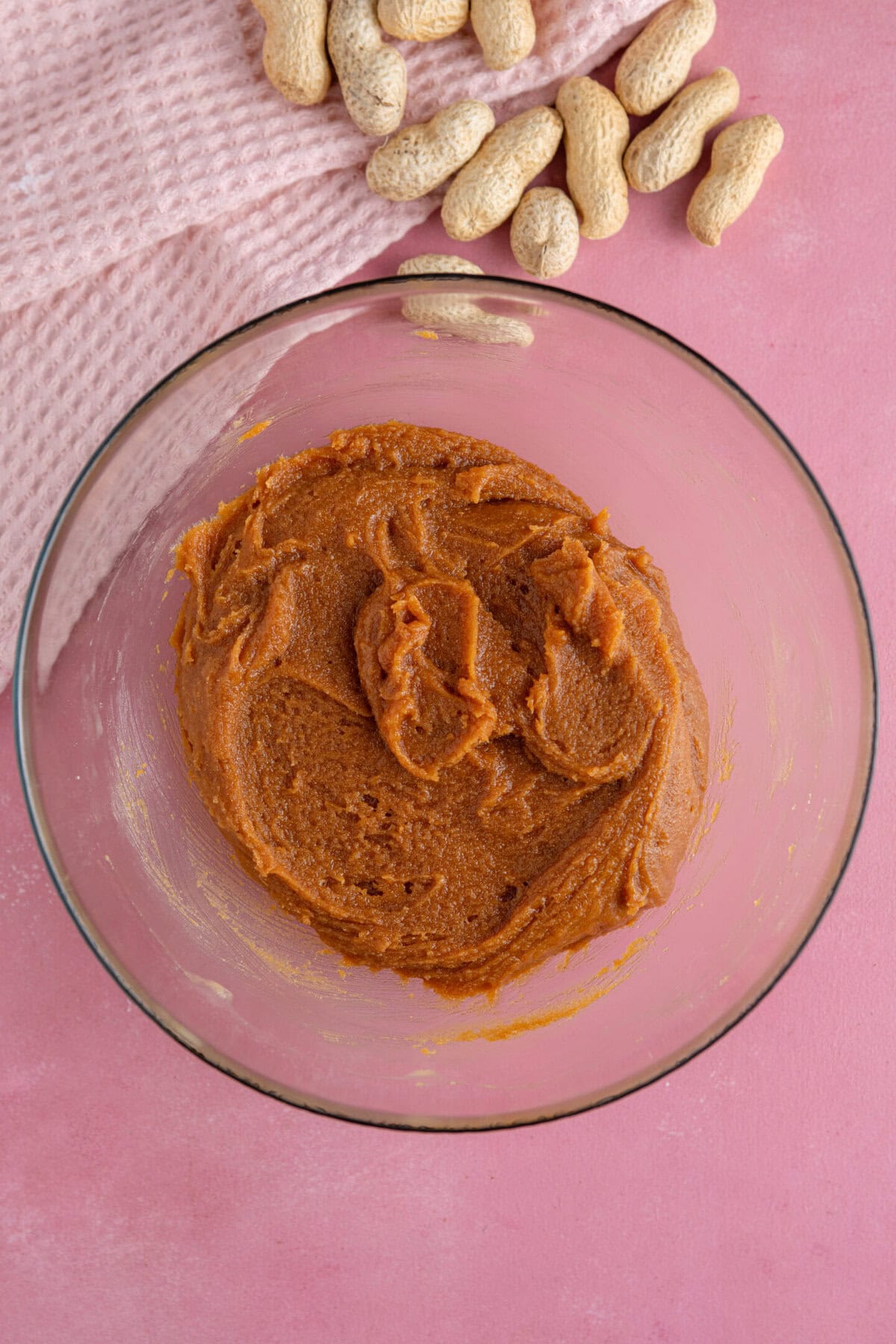 Process shot of peanut butter cookies showing the peanut butter, egg and sugar mixed together.
