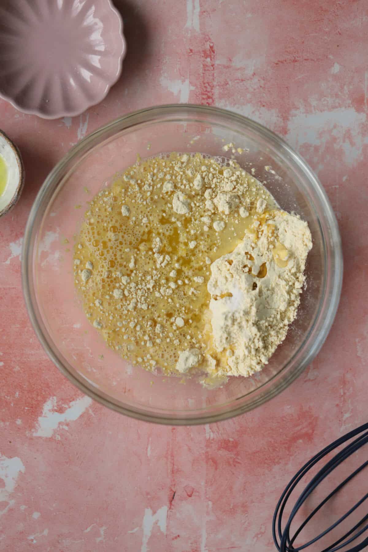 Process shot of gluten free socca recipe showing the ingredients in a bowl.