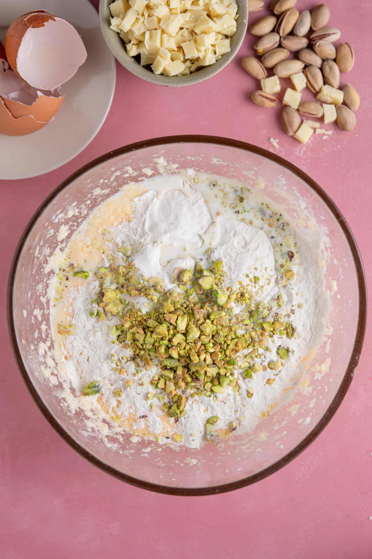 Process shot of pistachio cake recipe showing the dry ingredients added to the cake batter.