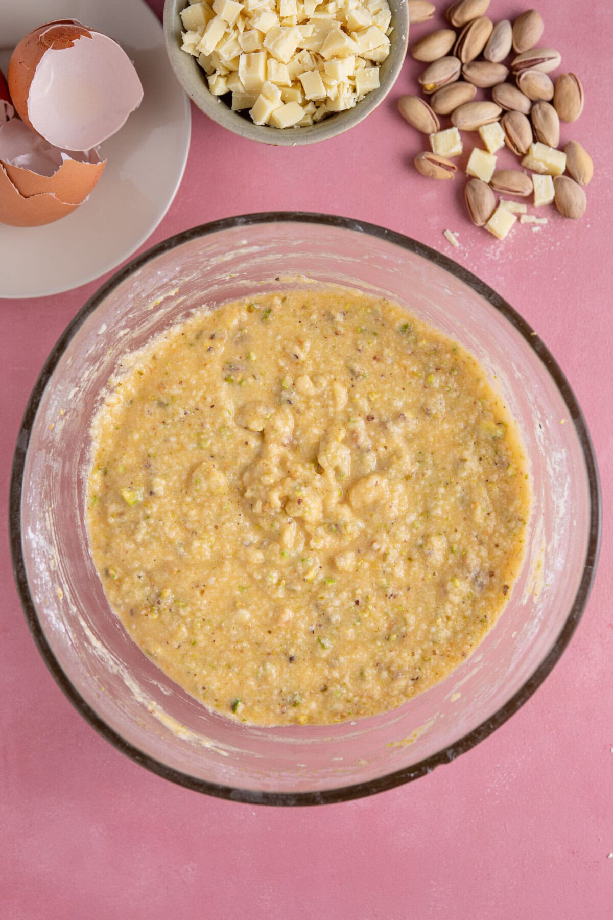 Process shot of pistachio cake recipe showing the cake batter in a mixing bowl.