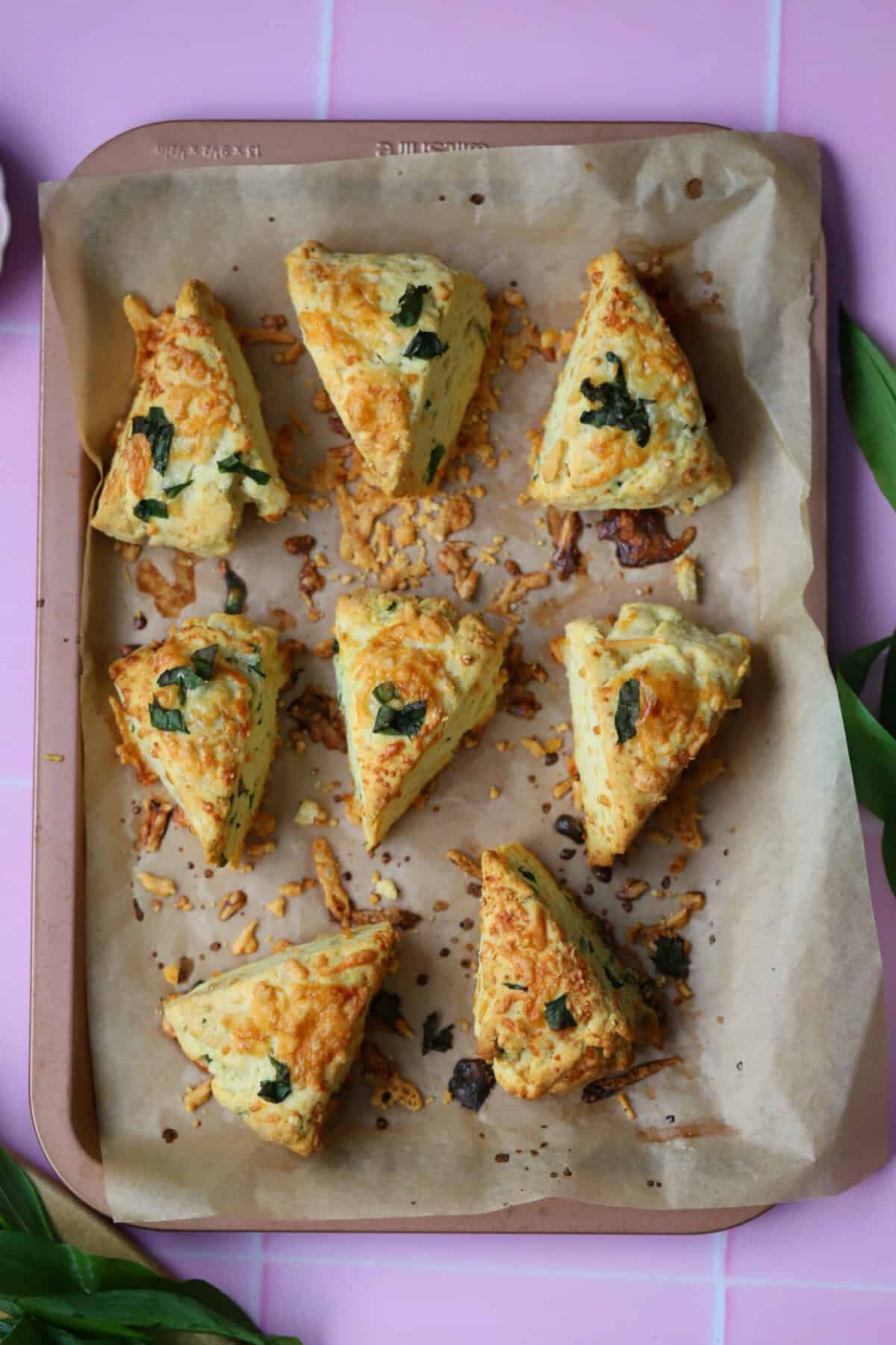 Process shot of cheese and wild garlic scones recipe showing the finished scones on a baking tray.