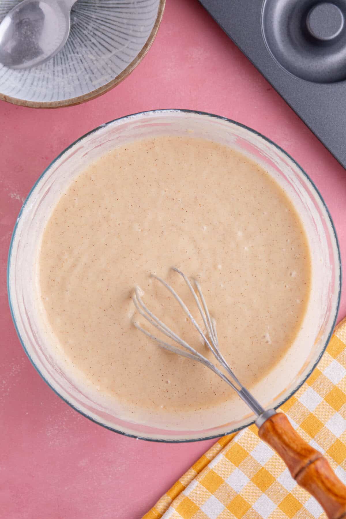 Process shot for gluten free doughnuts recipe showing the batter in a bowl.