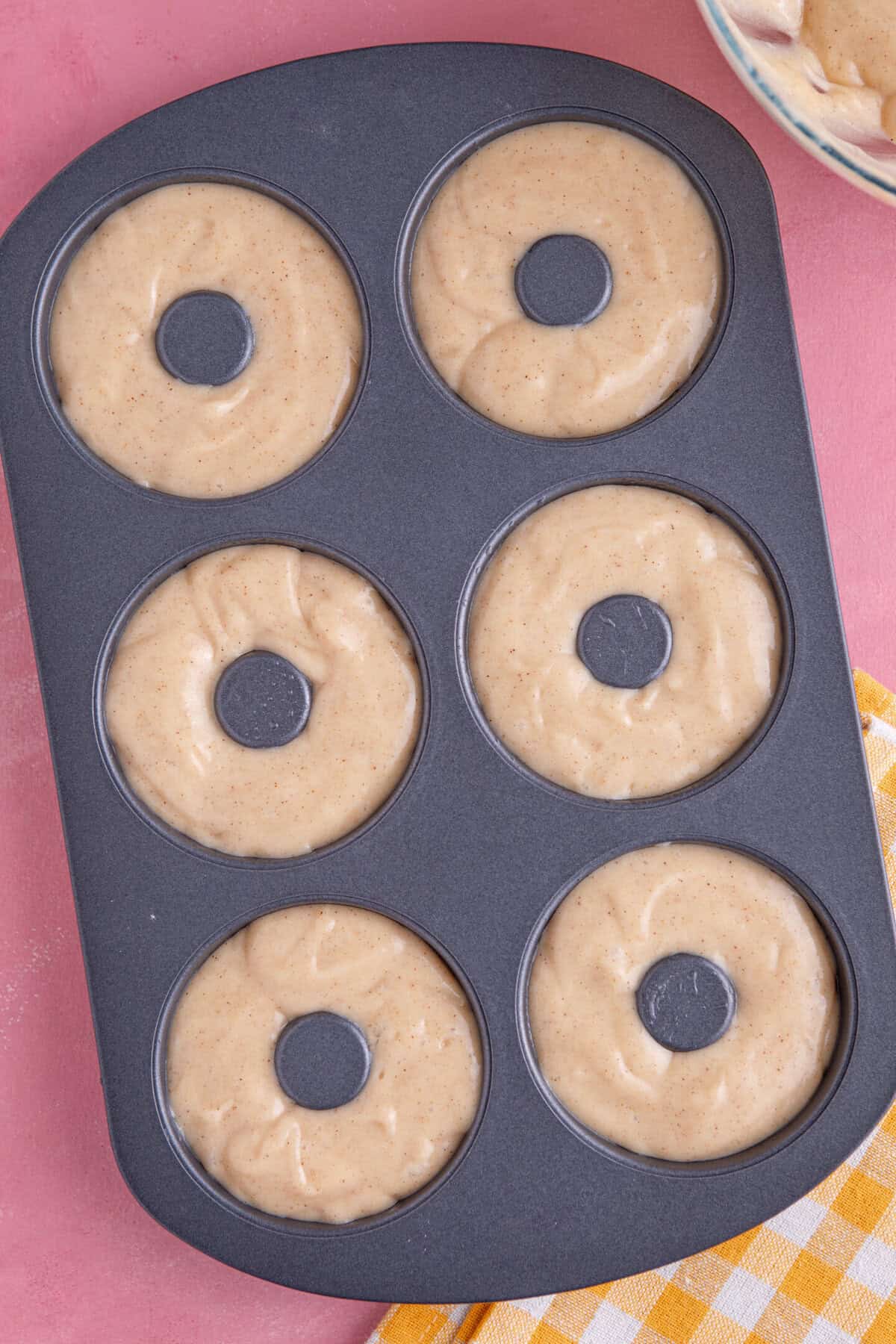 Process shot for gluten free doughnuts recipe showing the batter in the donut tin before baking.