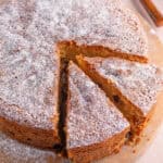 A gluten free fruit cake with two slices cut from it ready to serve.