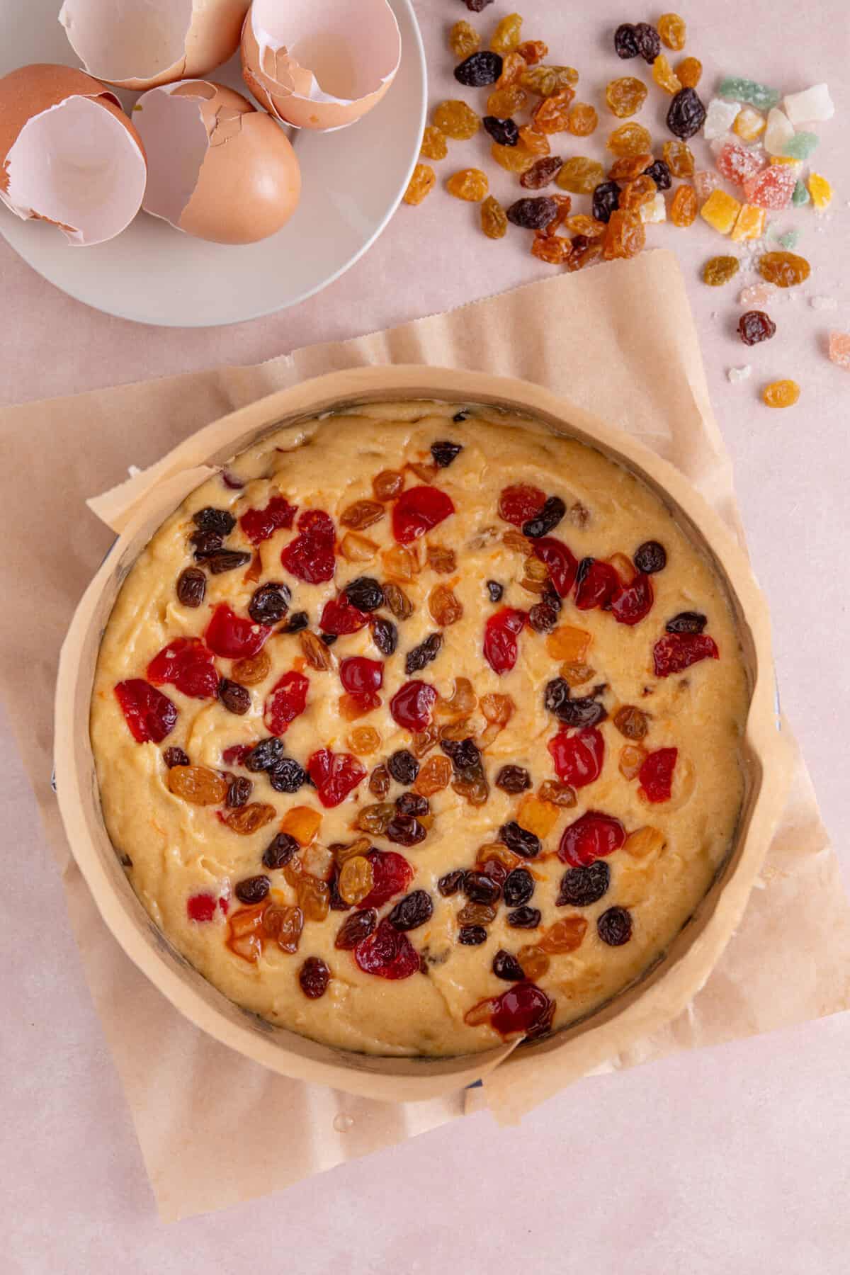 Process shot of a gluten free fruit cake recipe showing the uncooked cake in the tin.