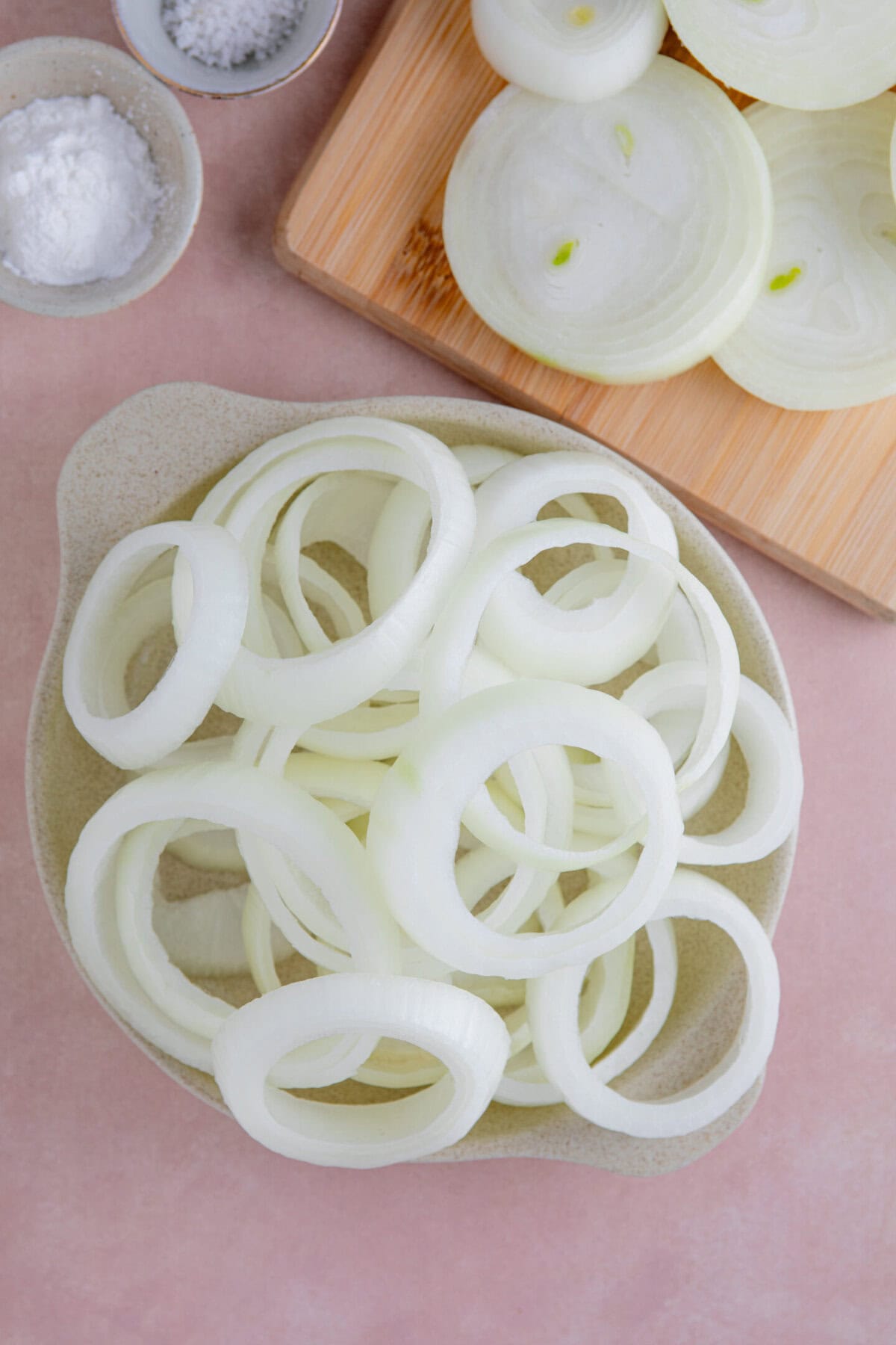 Slices of onions broken into rings.