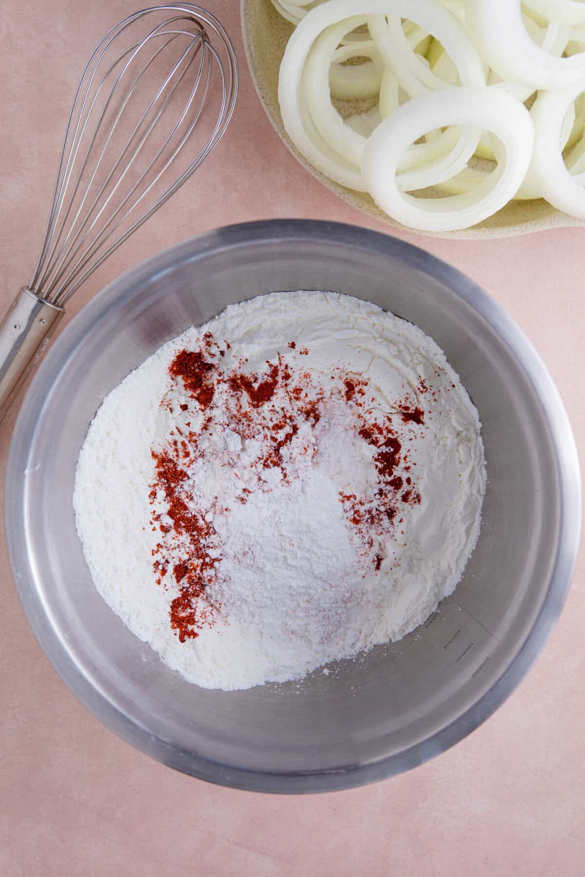 A bowl with the dry ingredients for the batter mixed together.