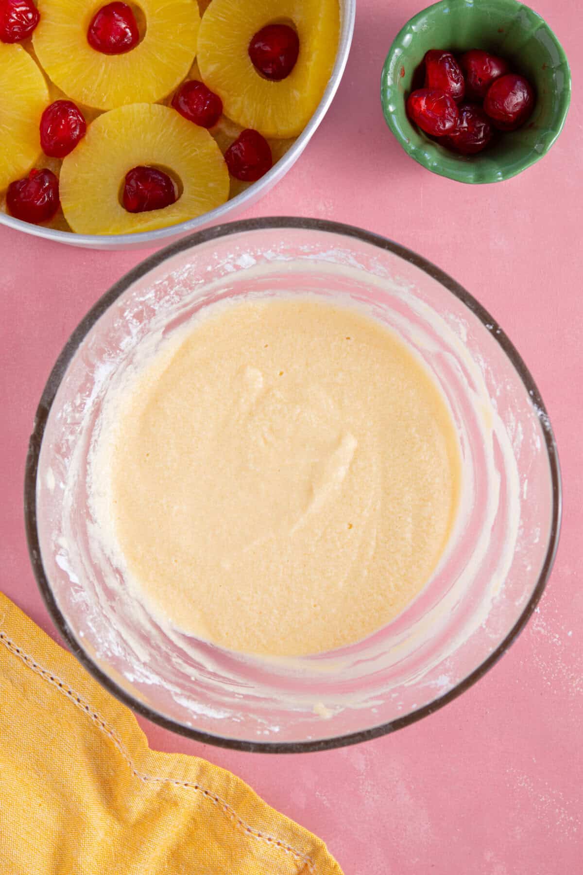 Process shot of a pineapple upside down cake showing the cake batter in a mixing bowl.