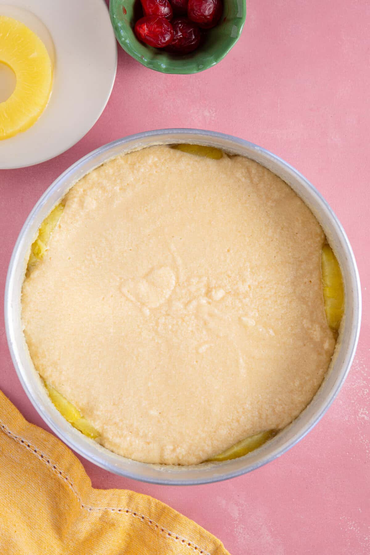 Process shot of a pineapple upside down cake showing the cake ready for baking.