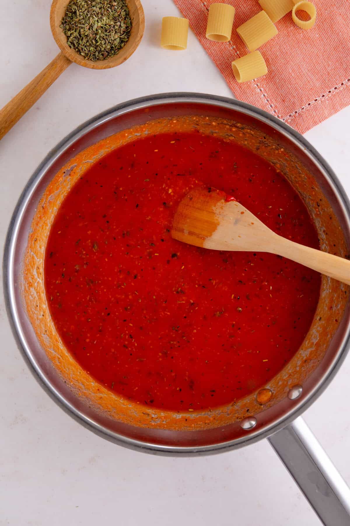 Process shot of tomato burrata pasta recipe showing the tomato pasta sauce before adding the cream.