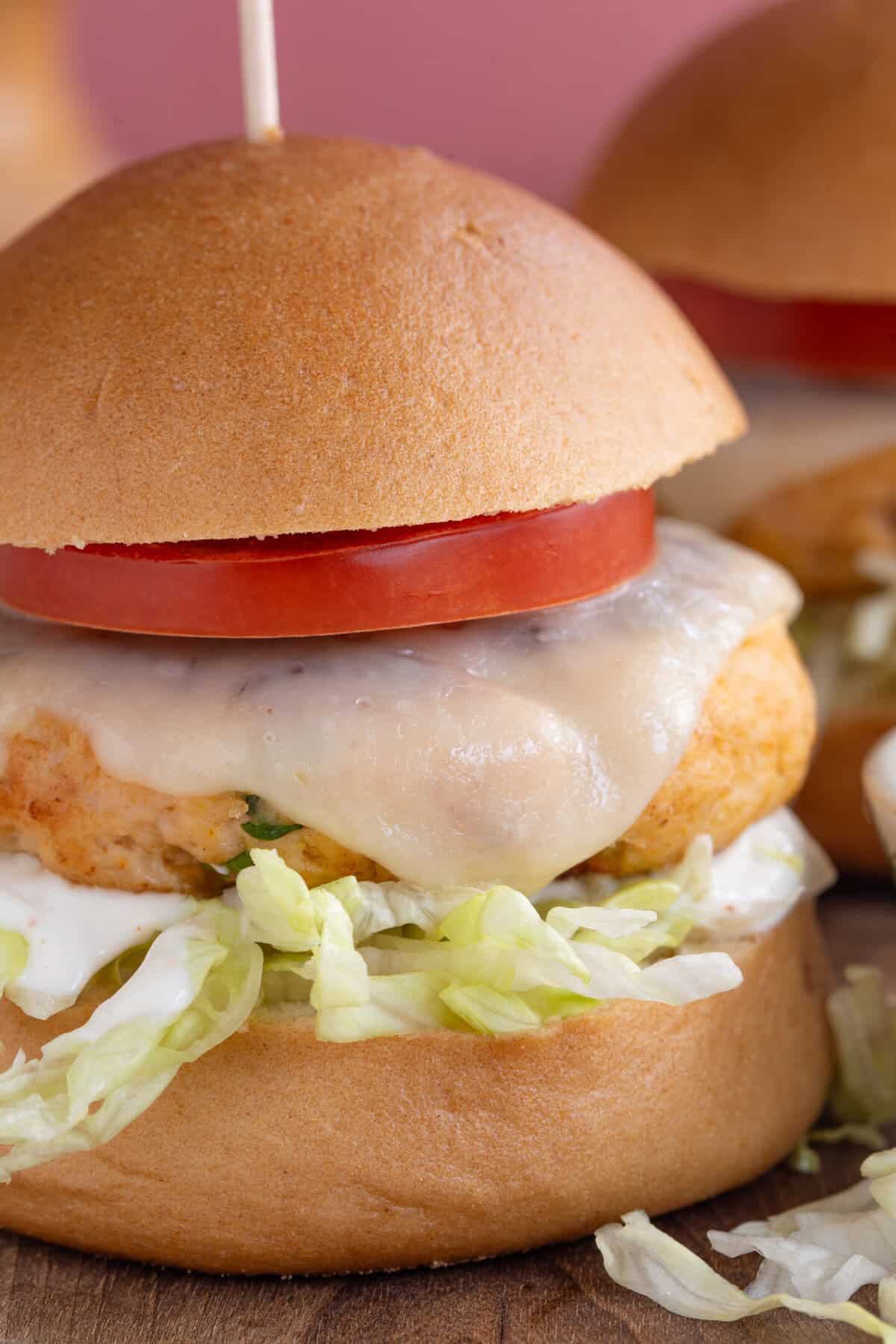 A finished chicken burger in a bun.
