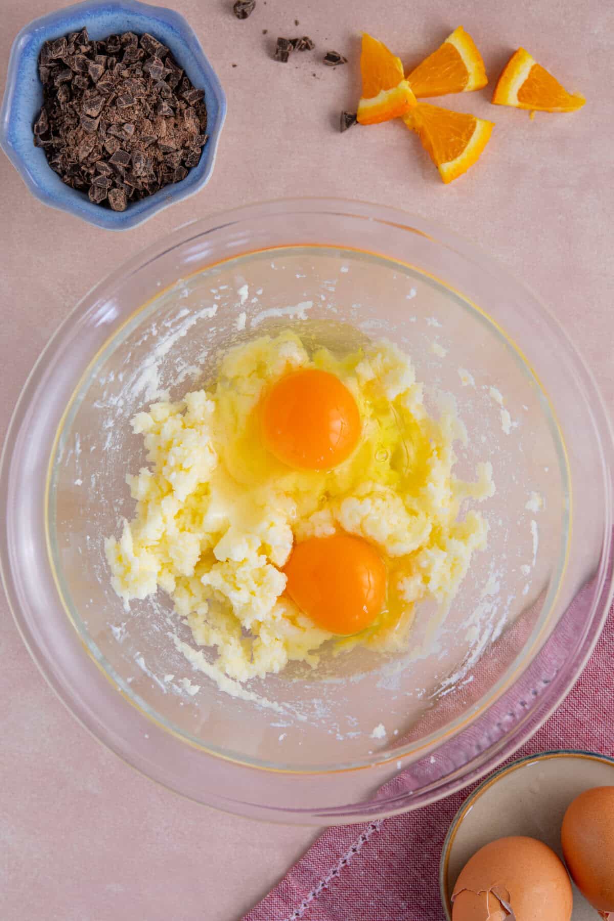 Process shot of gluten free chocolate orange cupcakes showing the eggs added to the butter and sugar.