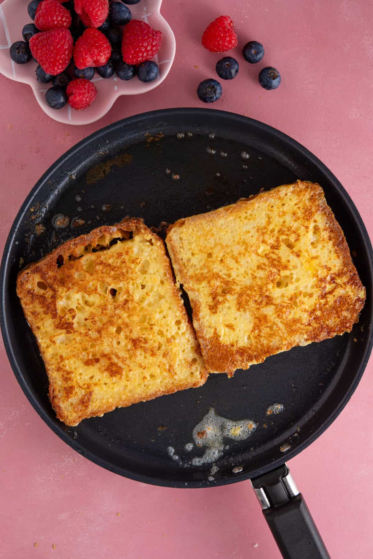 Process shot of gluten free French toast showing the cooked French toast in a pan.