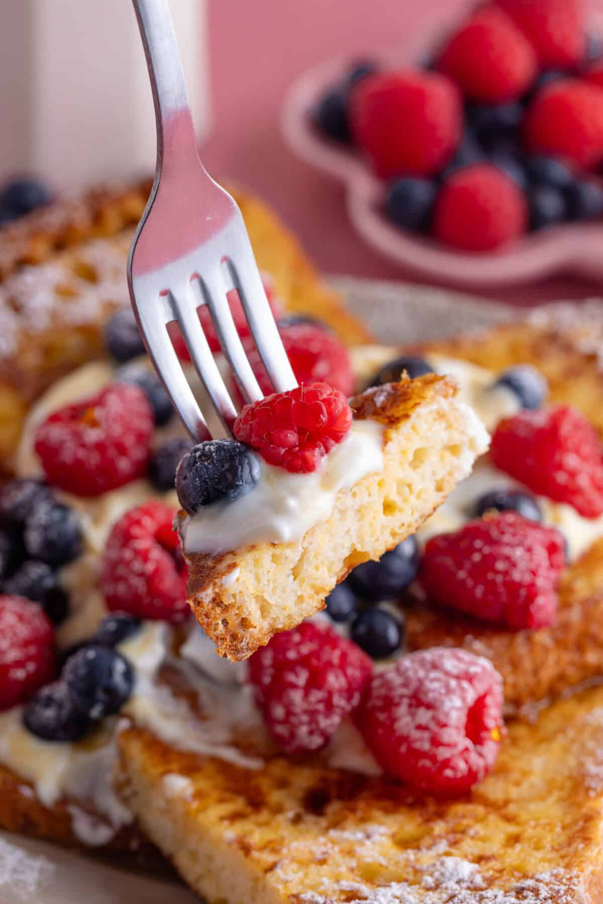 Close up of a fork full of gluten free French toast.