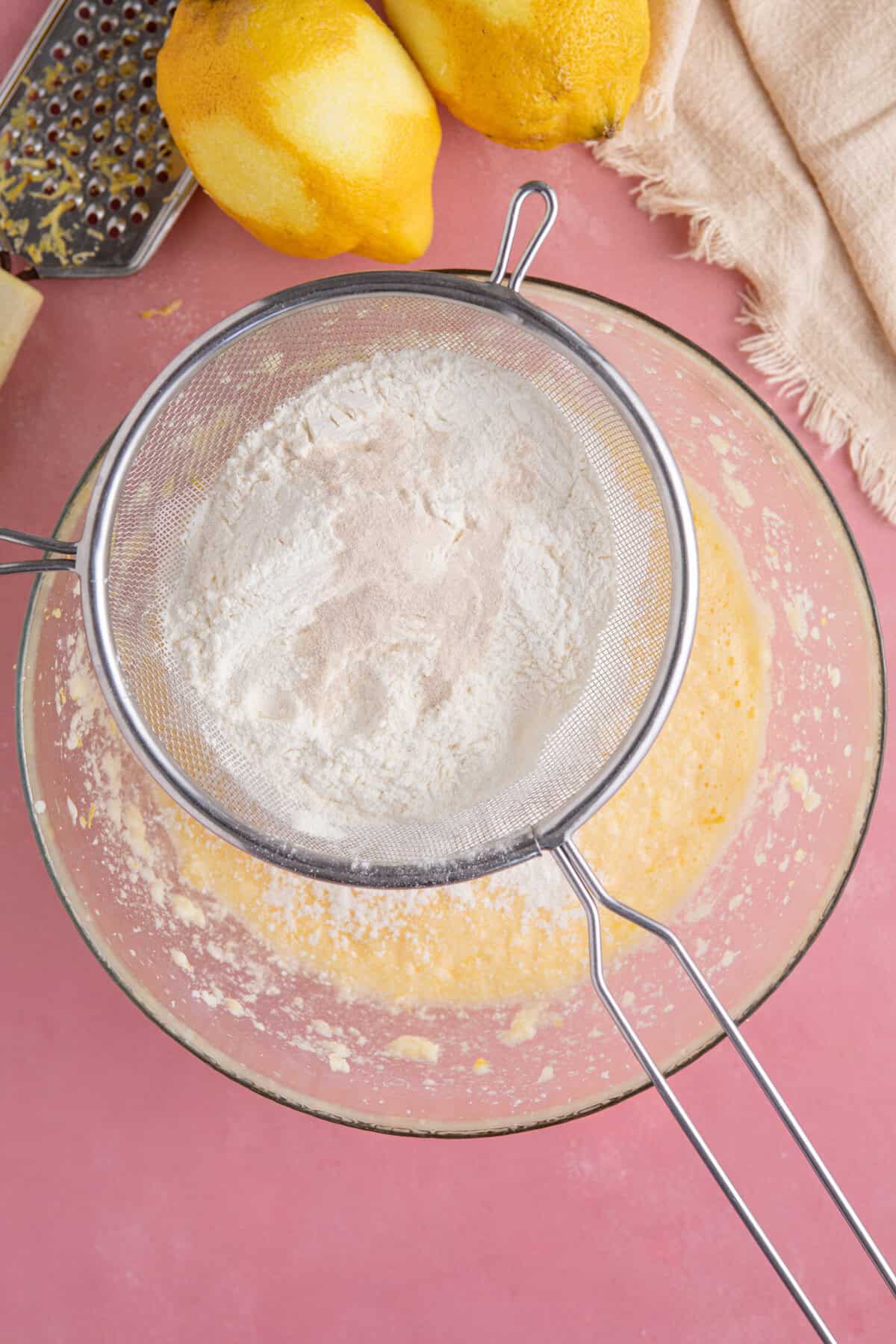 Process shot for gluten free lemon drizzle cupcakes showing the flour added to the cake batter.