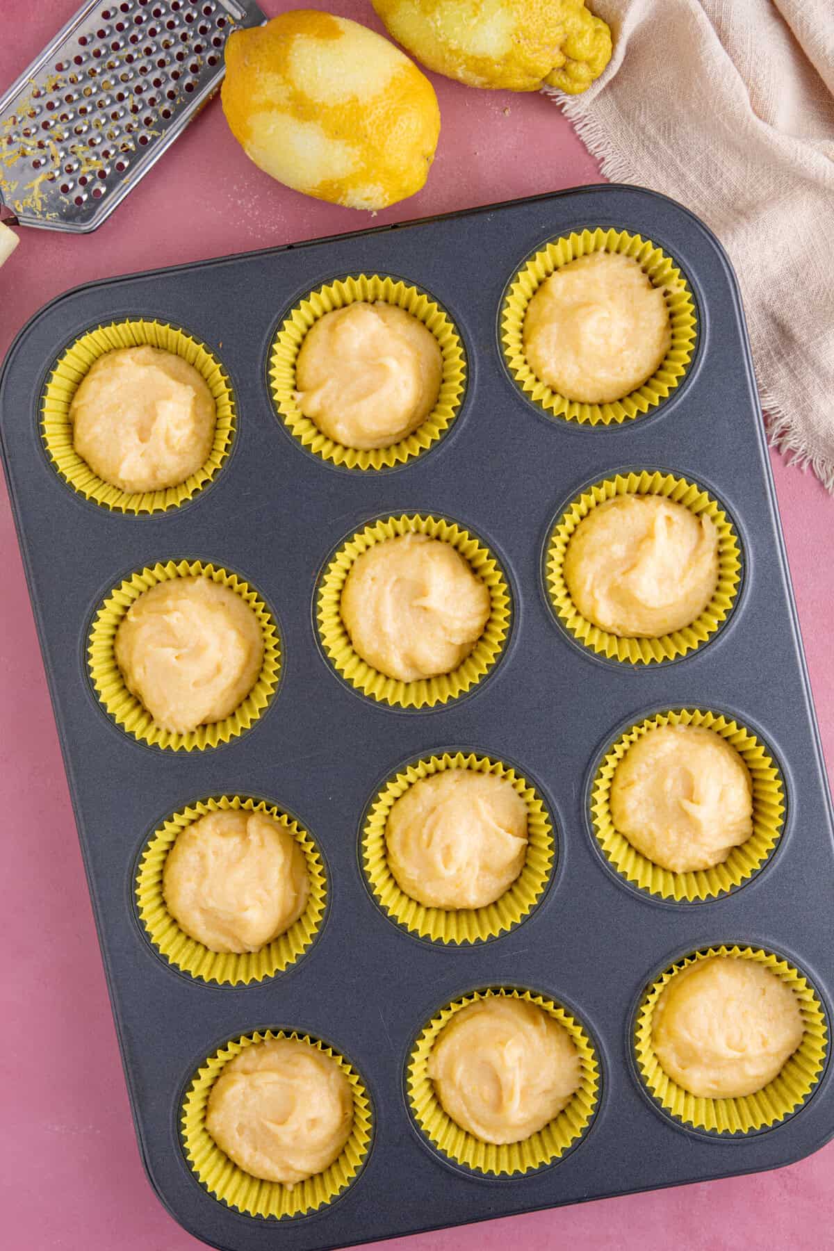 Process shot for gluten free lemon drizzle cupcakes showing the cupcake batter in cake cases.