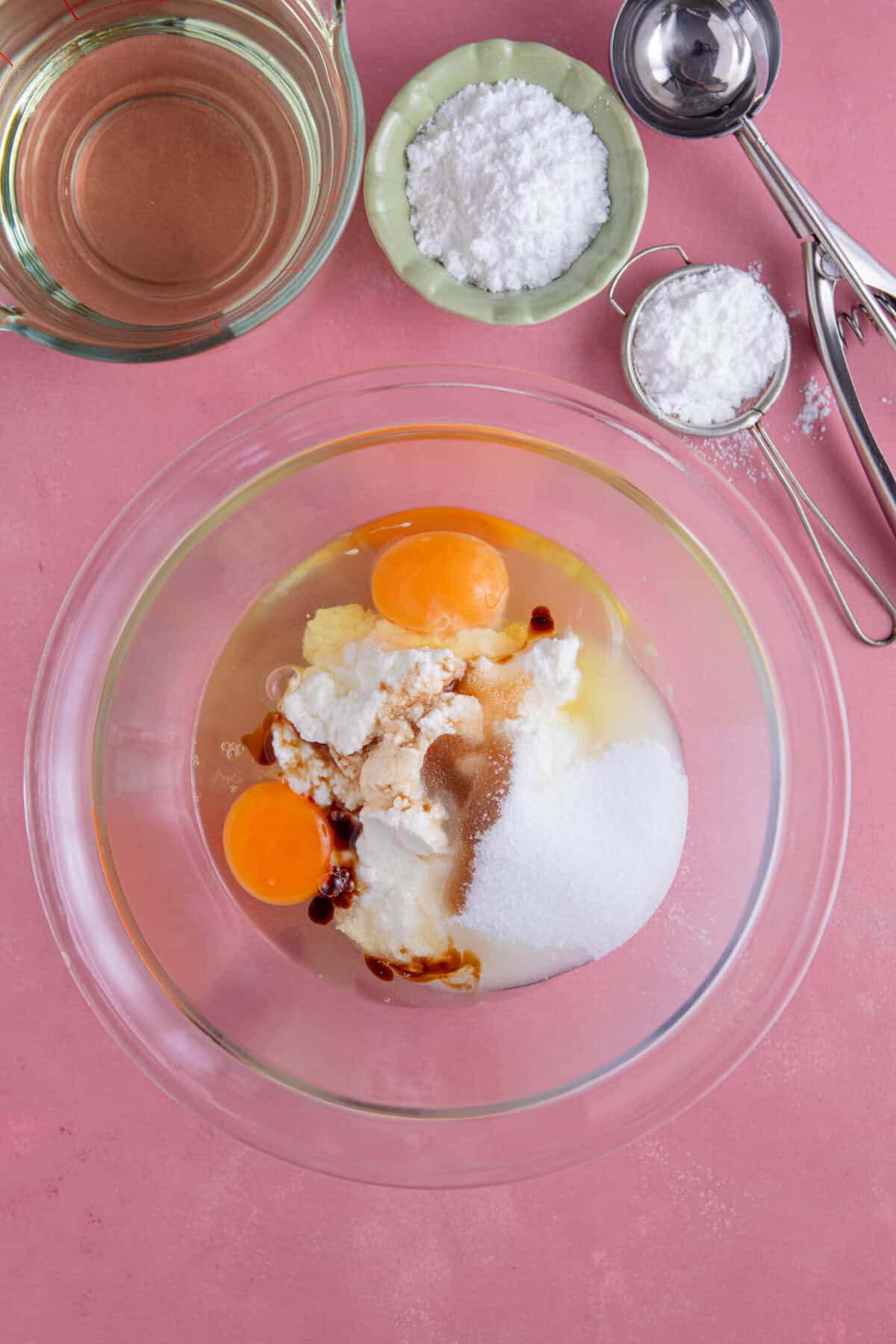 Process shot for gluten free zeppole showing the wet ingredients in a mixing bowl.