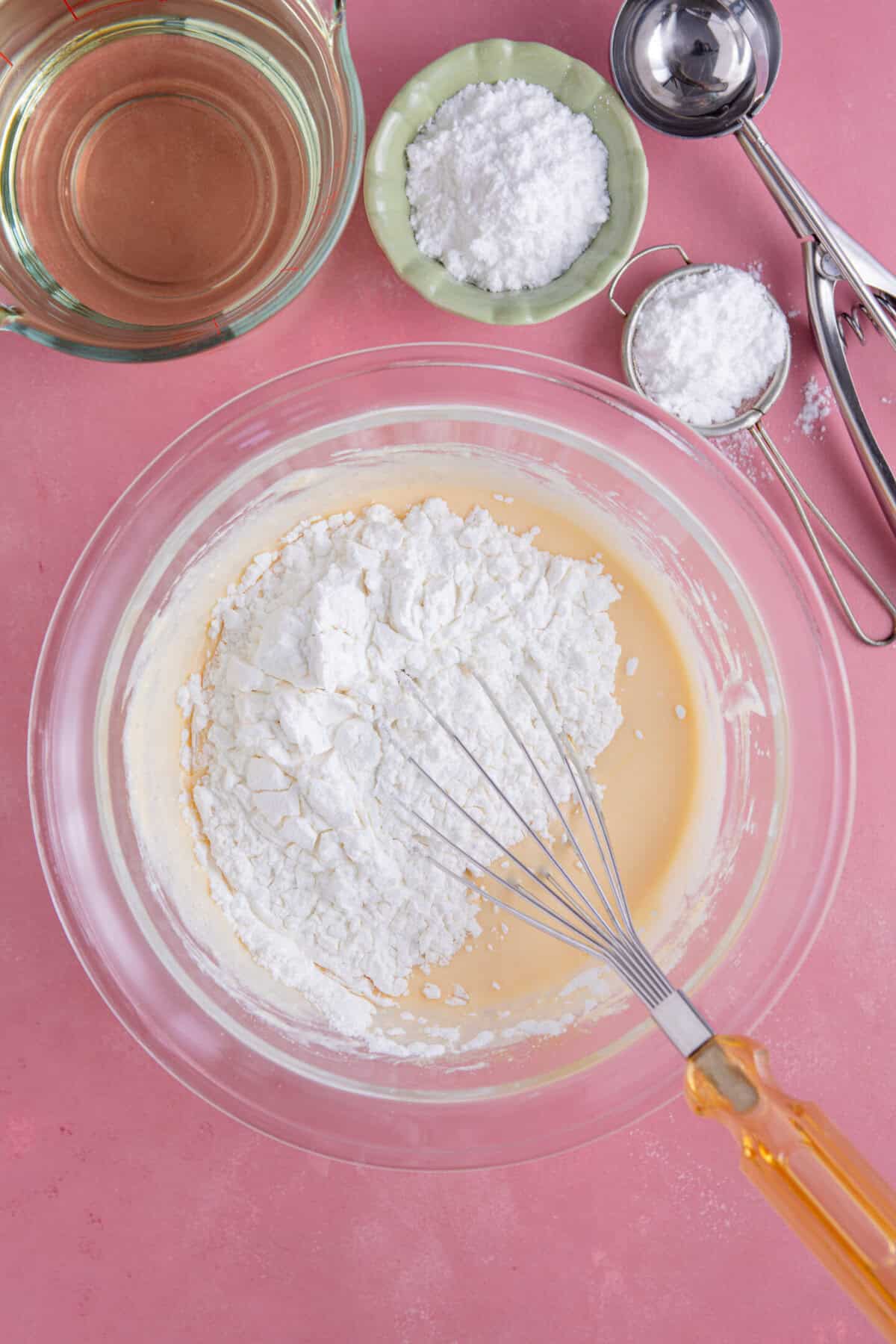 Process shot for gluten free zeppole showing the dry ingredients added to the wet ingredients.