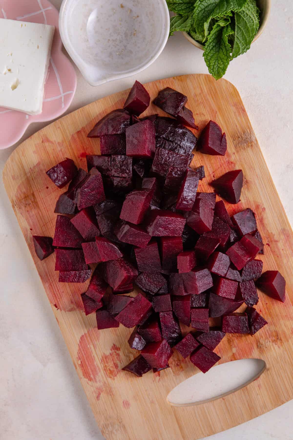 Process shot of beetroot salad recipe showing the cooked beetroot chopped up.