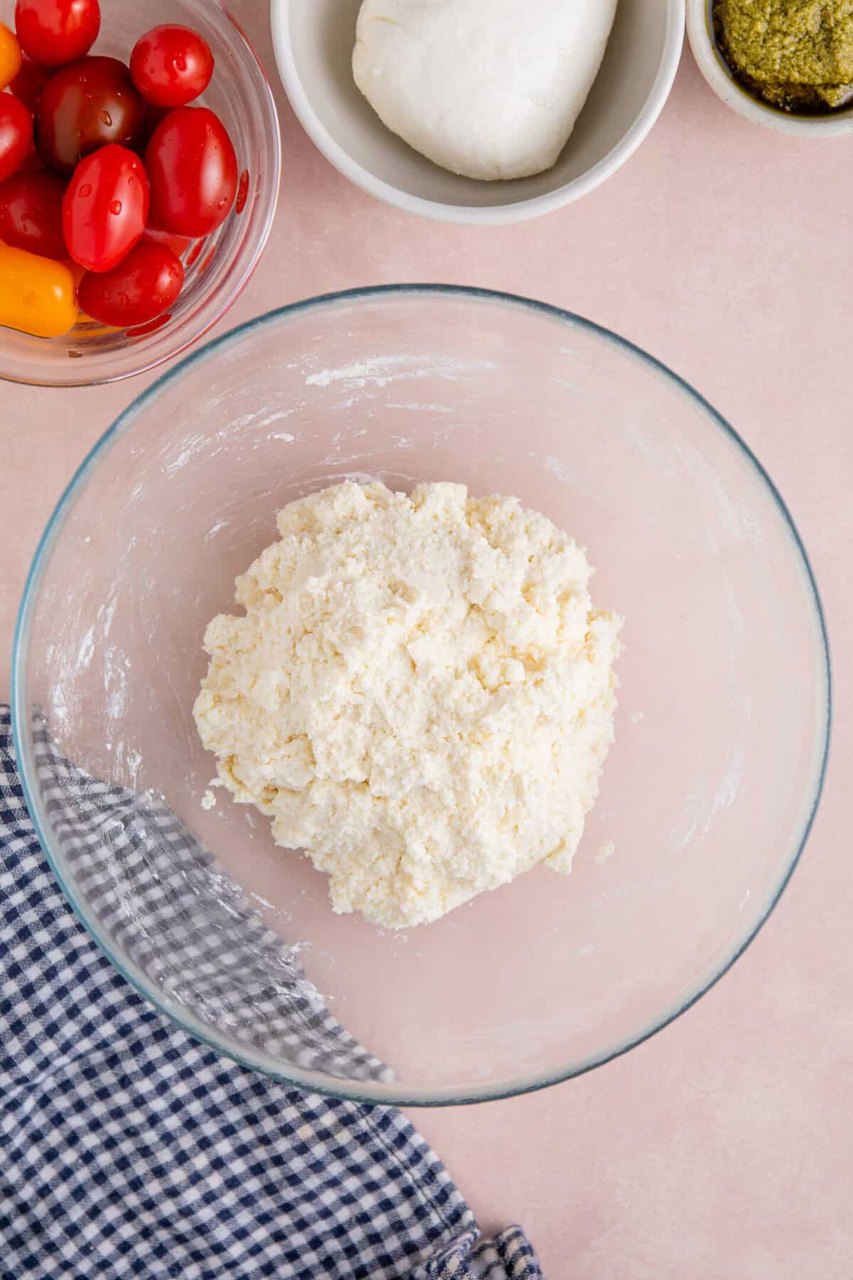Process shot of gluten free flatbread pizza recipe showing the yoghurt and flour mixed together into a dough.